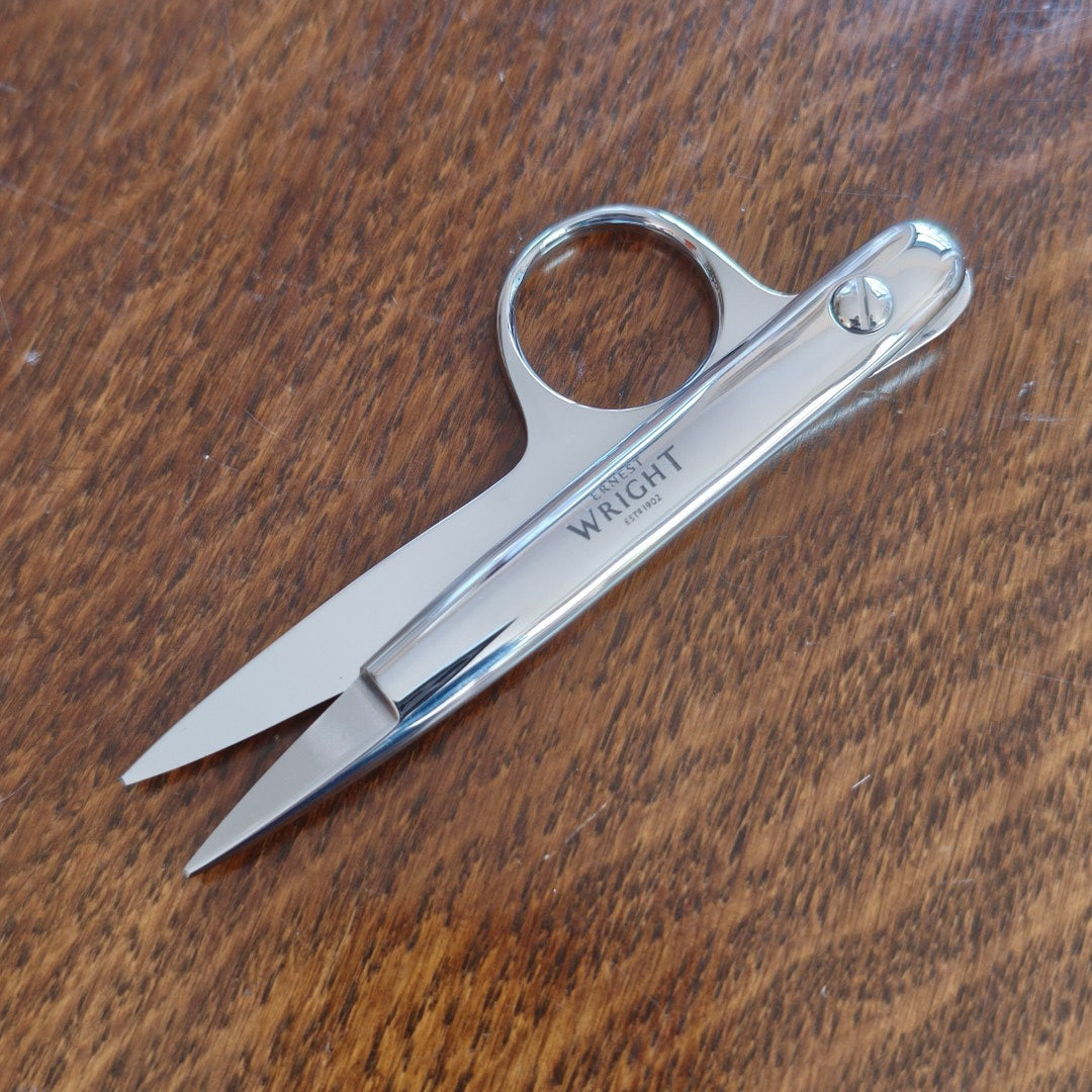 Silver snips with 'Ernest Wright' branding on a wooden surface