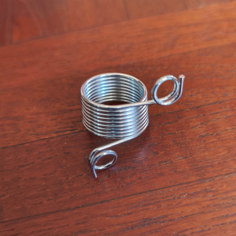Metal  knitting thimble on a wooden surface