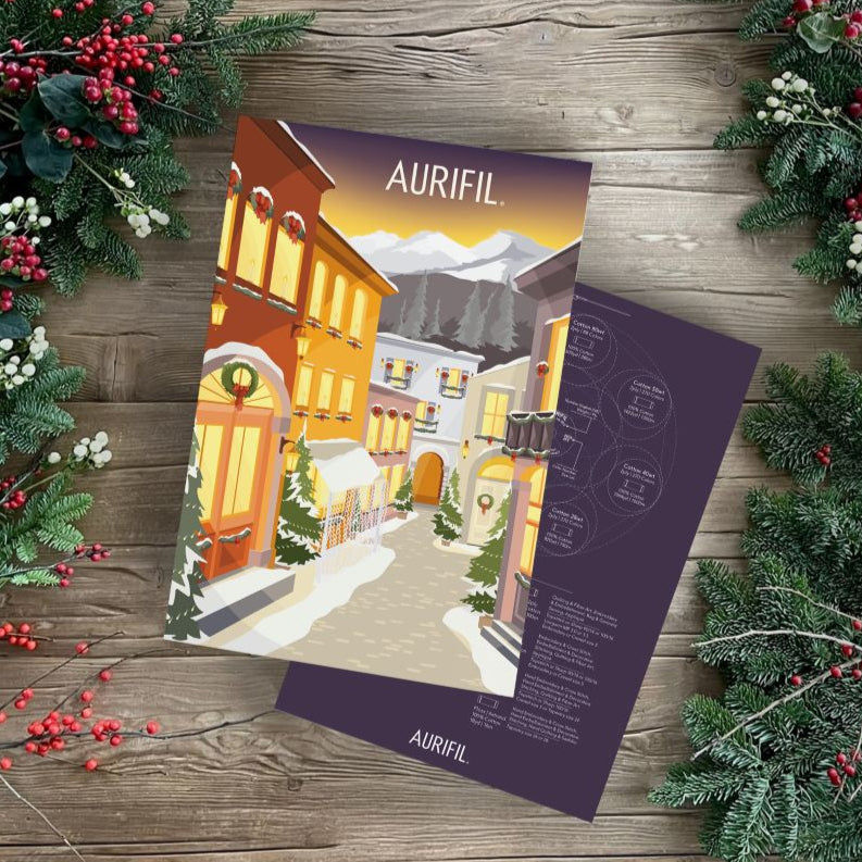 Aurifil product packaging on a wooden surface with Christmas decorations